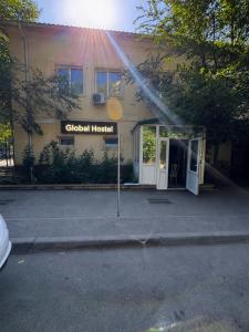 a building with a fire hydrant in front of a building at Global Hostel 3 in Almaty