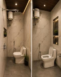 a bathroom with a toilet and a sink at Landmark Hotel in Jodhpur