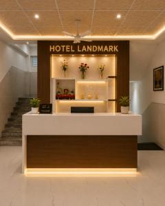 a hotel lobby with a hotel landmark sign on the wall at Landmark Hotel in Jodhpur