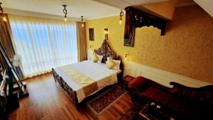 a bedroom with a bed and a couch at Kali Tibba Resort Chail in Chail