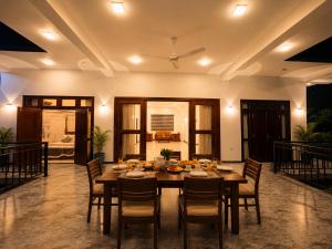 a large dining room with a table and chairs at Danketiya Palace in Ahangama