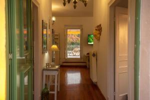 a hallway with a door leading to a patio at Casa Sulla Montagna North Corfu in Loútsai