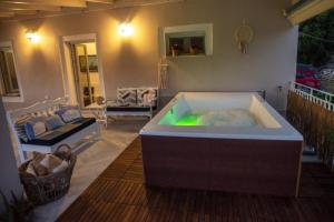 a jacuzzi tub sitting on a porch at Casa Sulla Montagna North Corfu in Loútsai
