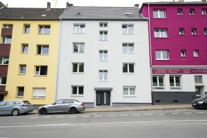 a row of brightly colored buildings on a street at Shin West in Essen