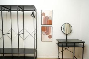 a room with a table and a mirror at Shin West in Essen +29 photos