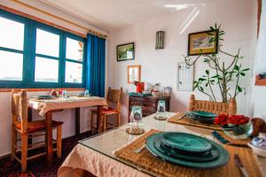 a dining room with a table with plates on it at Riad Le Cheval Blanc in Safi