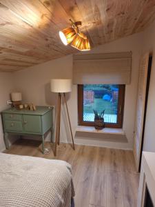 a bedroom with a bed and a window at Nadmorska Przystań in Gdańsk
