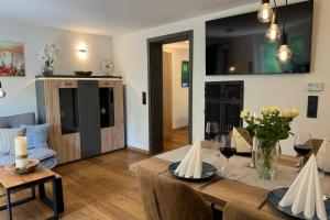a living room with a dining room table with wine glasses at Relax Apartment Lakewalk in Friedrichshafen +11 photos