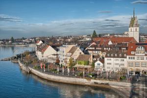 a city next to a body of water with buildings at Relax Apartment Lakewalk in Friedrichshafen