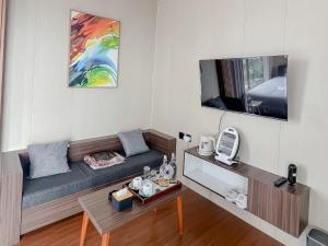 a living room with a couch and a tv at 1440 MDPL Villa & Resort in Wonosobo +35 photos