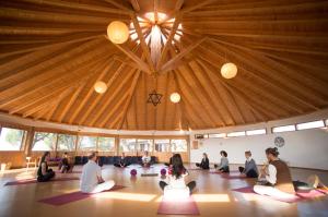 a group of people sitting on the floor in a room at Monte Velho Retreat Centre in Aljezur