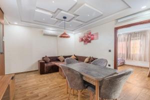 a living room with a table and a couch at Elmoapart in Agadir +20 photos