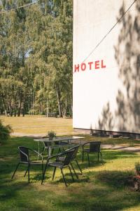 a group of tables and chairs in a field at Minhauzena Unda in Saulkrasti