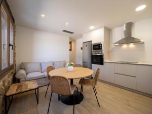 a kitchen and living room with a table and a couch at mu APARTAMENTOS RURALES in Albella
