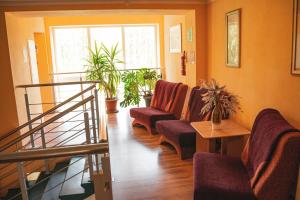 a living room with two chairs and a staircase at Minhauzena Unda in Saulkrasti