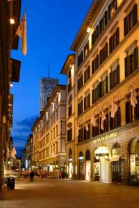 a city street filled with lots of tall buildings at FH55 Hotel Calzaiuoli in Florence