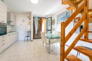 a kitchen and dining room with a table and chairs at Apartment Ampio in Lido degli Estensi