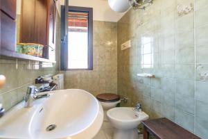 a bathroom with a sink and a toilet at Apartment Ampio in Lido degli Estensi +37 photos