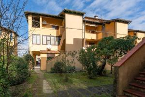 an apartment building with a staircase in front of it at Apartment Ampio in Lido degli Estensi