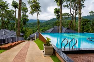 a swimming pool with a view of a mountain at Silent Brook Resort - Coorg in Madikeri