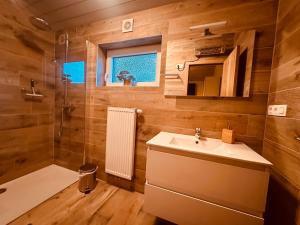 a bathroom with a sink and a shower at Chalet des Campanules avec Sauna in Vielsalm +42 photos