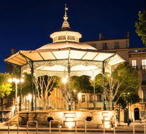 a gazebo in front of a building at night at Hôtel Faculté in Marseille