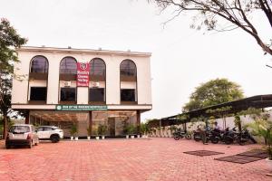 a building with motorcycles parked in front of it at Mandu's Green Valley Resort in Māndu