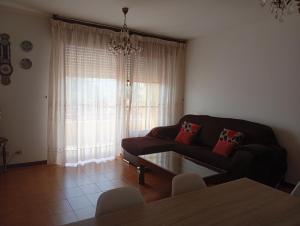 a living room with a couch and a table at Piso centro de Raxò in Raxó