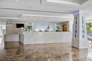 a man standing at a counter in a room at Hotel Luxor in Playa de Palma +110 photos