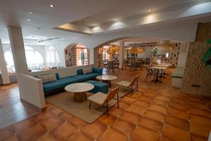 a living room with a blue couch and tables at Intelier Bonaire in Benicàssim