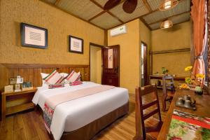 a bedroom with a large white bed and a table at Ui Valley Resort in Ninh Binh +79 photos