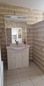 a bathroom with a sink and a mirror at L'escapade in Rétaud +2 photos