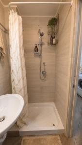 a bathroom with a shower and a sink at the sea beyond in Castellammare di Stabia +28 photos