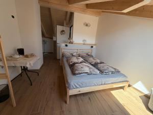 a bed in a room with a wooden floor at Dalla zia Gemma in Carano +1 photo