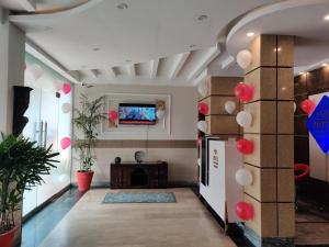 a hallway with red and white balloons on the wall at Swiss Pearl Hotel Lahore in Lahore