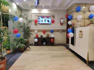 a room with red and blue balloons and a tv at Swiss Pearl Hotel Lahore in Lahore