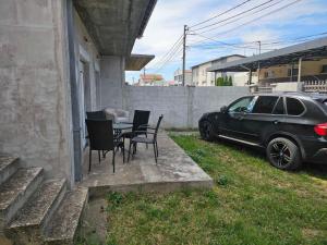 a car parked next to a house with a table and chairs at Beogradski mir in Belgrade