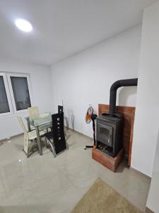 a living room with a stove and a table at Beogradski mir in Belgrade