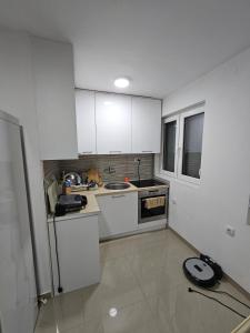 a small kitchen with a sink and a refrigerator at Beogradski mir in Belgrade