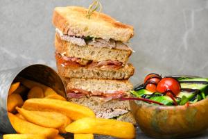 a sandwich and french fries and a bowl of vegetables at Riverside Holiday Park in Amberley +5 photos