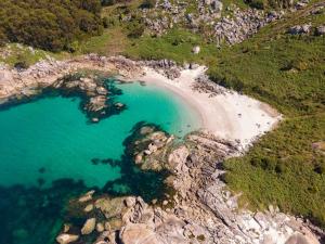an aerial view of a beach with blue water at Rincón Atlántico ático deluxe in Moaña +21 photos