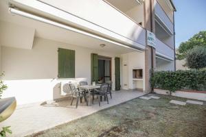 a patio with a table and chairs in a building at Residence Smith Sul Mare in Lido degli Estensi +20 photos