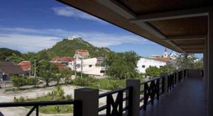 a balcony with a view of a mountain at Baan Chomphu in Prachuap Khiri Khan
