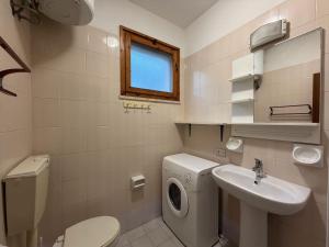 a bathroom with a washing machine and a sink at Residenza Emilia in Lido degli Estensi +54 photos