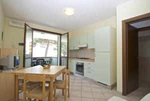 a kitchen with a table and a dining room at Smith 3B in Lido degli Estensi +13 photos