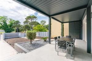 a covered patio with a table and chairs on it at VILLA TASSO 25 BILO in Lido degli Estensi