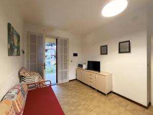a living room with a couch and a television at Villette Astoria in Lido degli Estensi