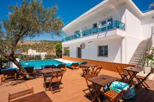 a villa with a swimming pool and a wooden deck at Villa Abiori in Ksamil
