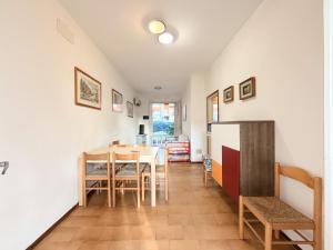 a kitchen and dining room with a table and chairs at Villette Astoria in Lido degli Estensi