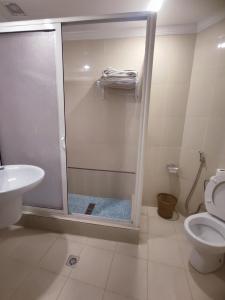 a bathroom with a shower with a toilet and a sink at Hotel Maamoura in Casablanca